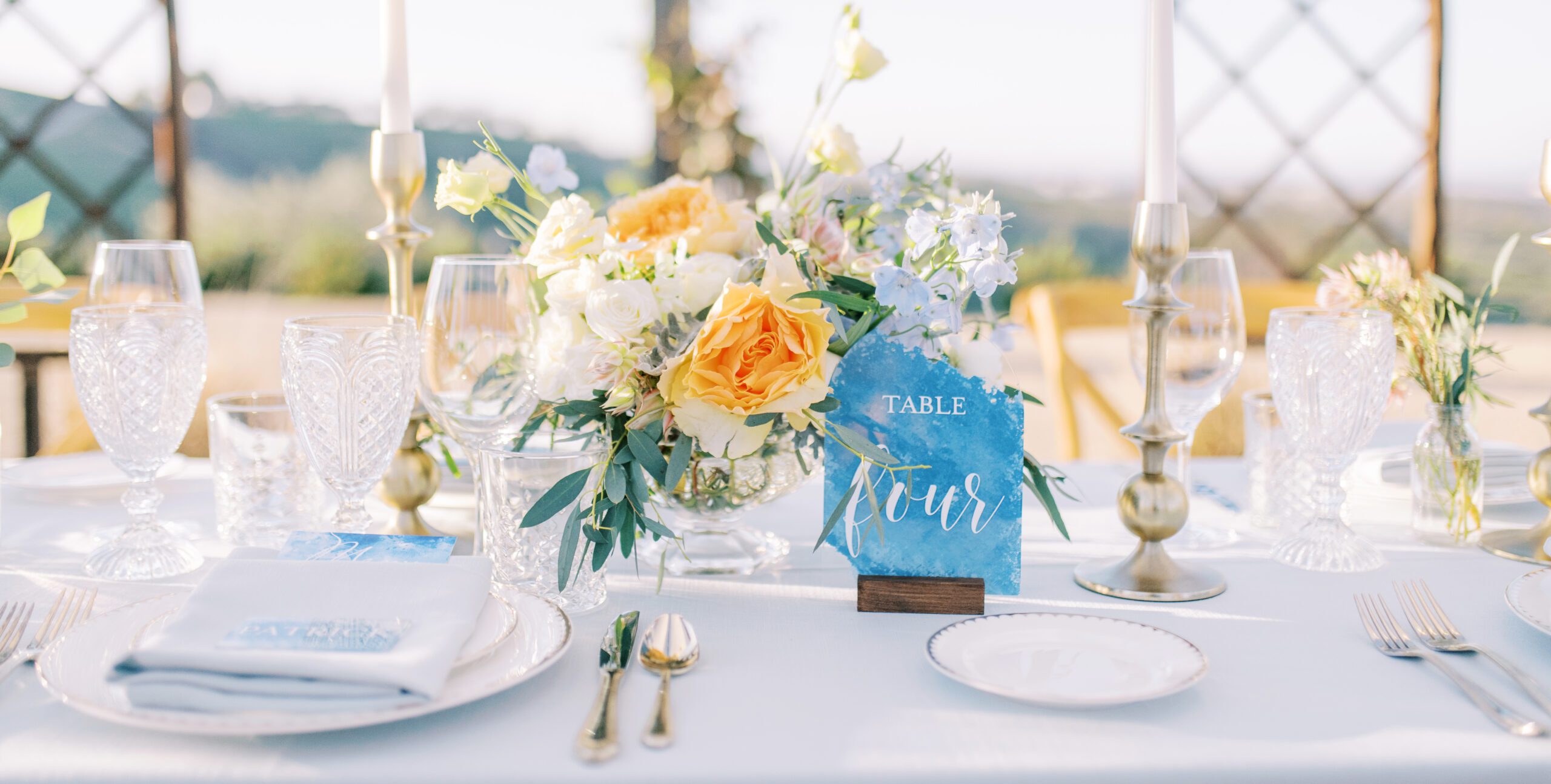 Beautiful watercolor blue and crystal clear glassware with accents of gold tablescape at Villa de Lucca, Templeton, CA planned by Outer Banks Wedding Planner, Jenna Nichols of Better2gether Events
