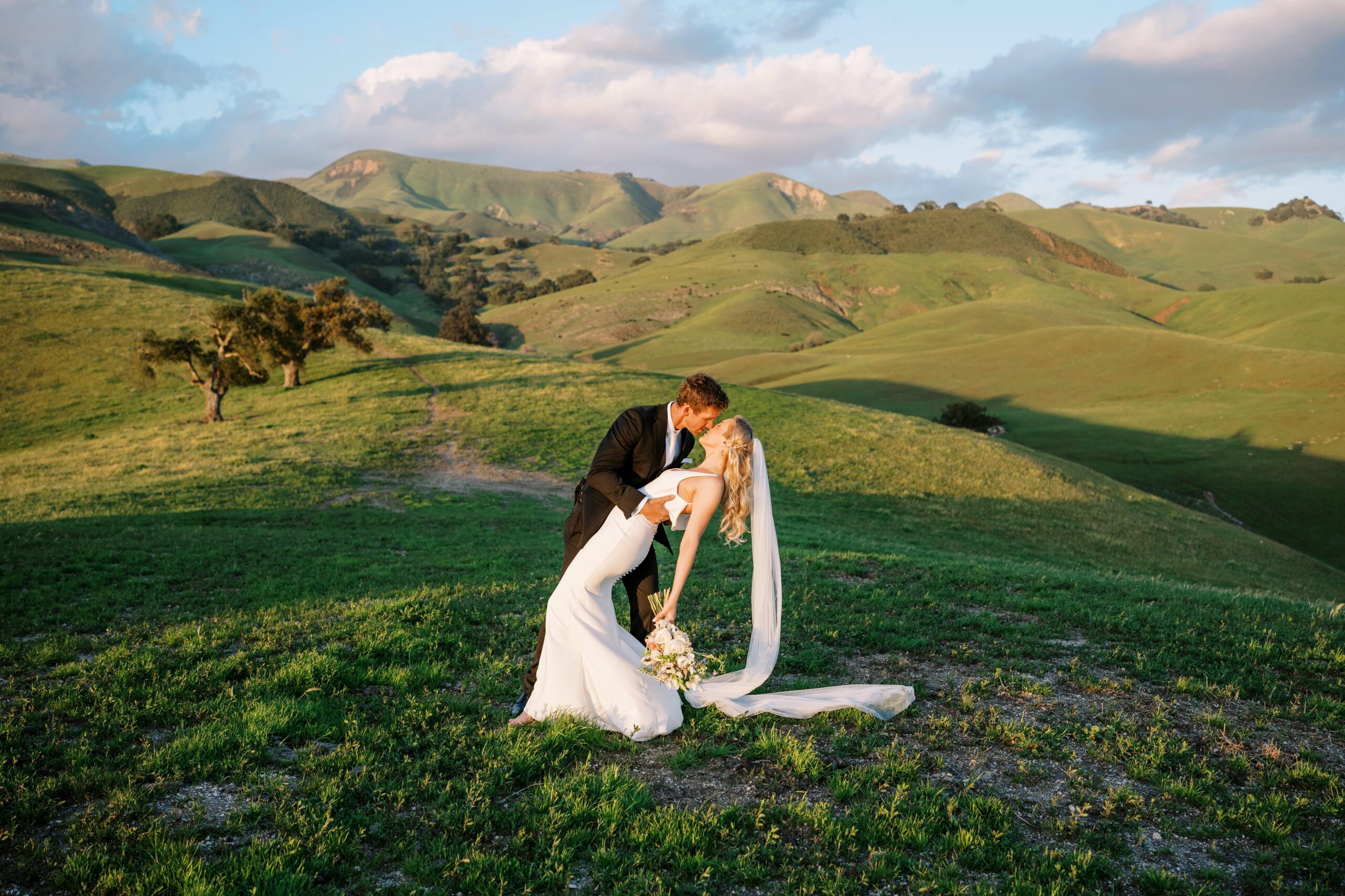 Groom dipping bride during golden hour portrait on a farm
